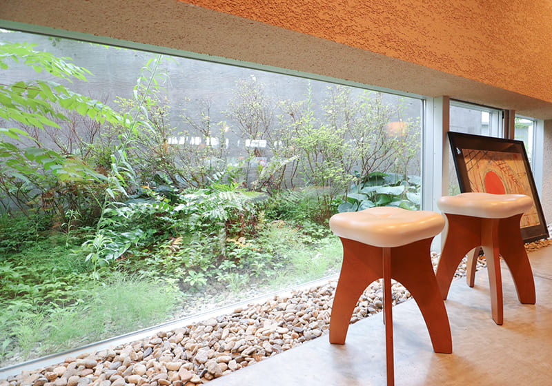 STOOTH stools by a garden window