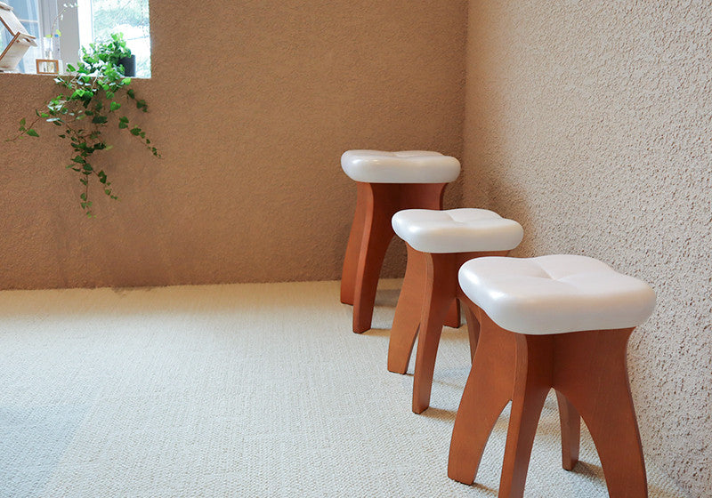 STOOTH stools against a textured wall